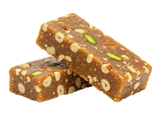 Two stacked pieces of dry fruit barfi with a rich brown color and nut-studded texture isolated on transparent background