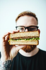 Hand holding sandwich showcases fresh ingredients with vibrant c