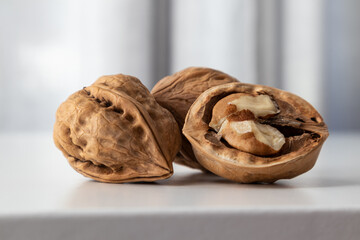 Walnut whole and half textured on a gray background front view with space for text.