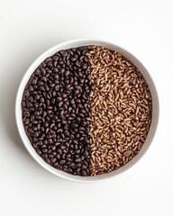 A bowl divided with dark roasted coffee beans on one side and light grains on the other, styled for culinary use