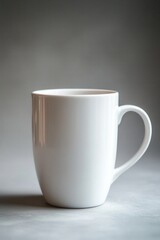 Obraz premium Minimalist Still Life of a Clean White Mug on a Neutral Gray Surface with Soft Lighting and Subtle Shadows for Serene Simplicity