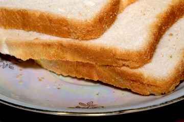 Slices of fresh bread resting on a decorative plate
