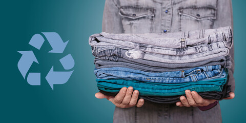 Female hands holding pre-loved garments with a recycling symbol in the background, emphasizing the...