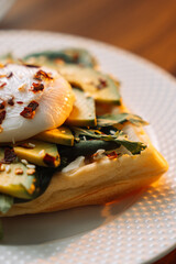 waffles with poached egg avocado on plate on wooden background