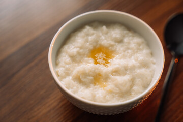 rice porridge with butter on wooden background