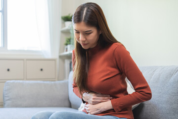 Flatulence ulcer, asian young woman, girl hands in belly, stomach pain from food poisoning,...