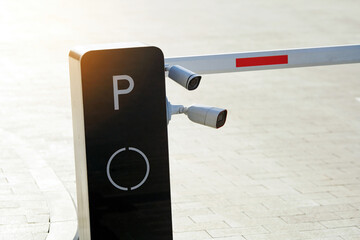 Security surveillance cameras mounted on parking entrance barrier, automated access control, real-time monitoring for vehicle entry and safety enforcement. Parking security system with CCTV cameras
