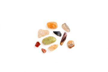 Top view of small colorful stones on white background