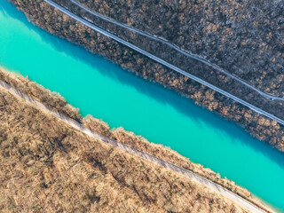 Soča River valley in Slovenia view from above. Asphalt road along the river. River with turquoise water in a canyon in winter season