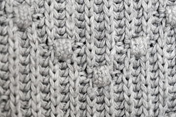 knitted texture, grey sweater or carpet. industrial knitting of clothes made of wool, acrylic or cotton. background, knitting