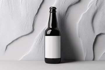 Sleek Bottle Mockup: A minimalist studio shot of a dark glass bottle featuring a blank white label, set against an abstract, textured background. Designed to spotlight your product in a modern.