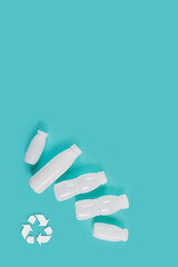 Overhead shot of plastic bottles on blue surface, advocating for sustainable packaging solutions and plastic-free alternatives.