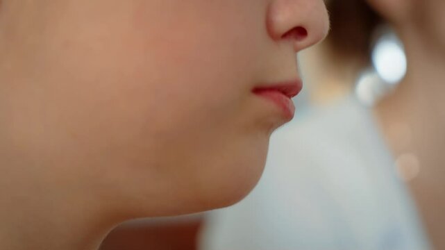 Girl chewing food close up. Kid savoring snack with focus on lips and jaw. Lady enjoying bite highlighting natural detail