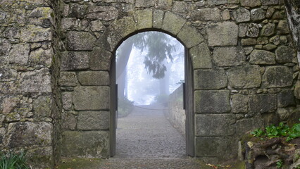 Arched Castle Gate with Atmospheric Mist through the Opening