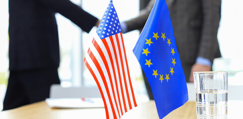 European Union and American leaders shaking hands on a deal agreement.