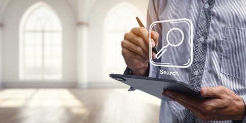 Man Searching for Information on Tablet in Modern Interior Space