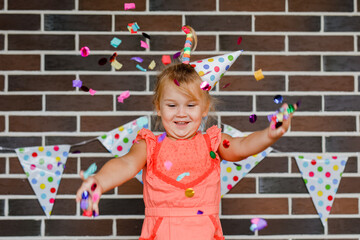Cute preschooler girl makes art at a summer outdoor party