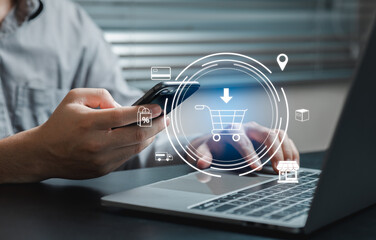 User Engaging with Smartphone While Shopping Online on Laptop