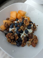 A Gluten free plant based fresh and healthy breakfast. Vegan yogurt topped with homemade grain free granola and fresh in season fruits- blueberry and cantaloupe. Filled with flavor and diversity.