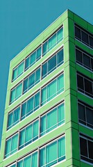 Fototapeta premium Green modern building, city, sunny day, glass windows, architecture, stock photo