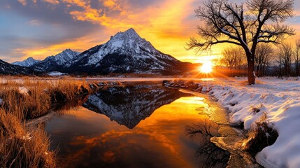 Majestic winter sunset over snowy mountains reflected in a tranquil creek