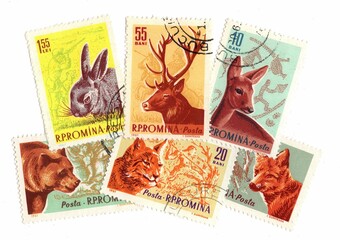 A set of vintage postage stamps from Romania on a white background.