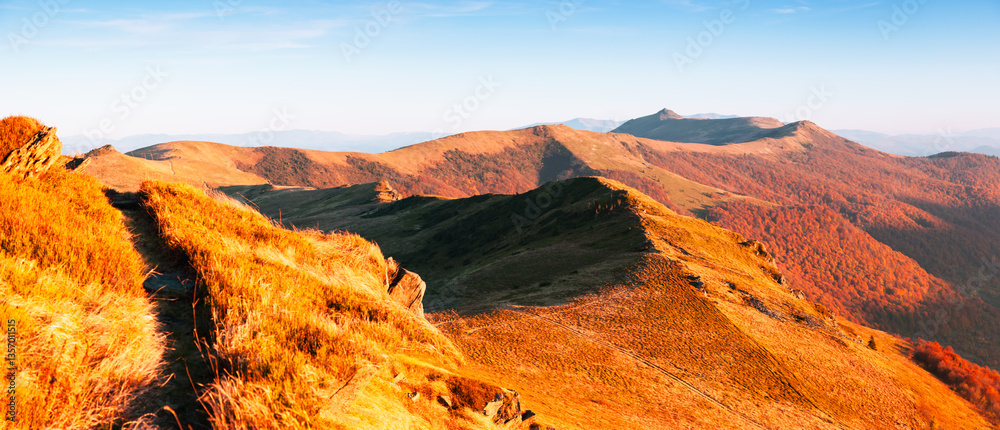 Aufkleber Gorgeous autumn mountain range extending into the distance are illuminated by sunlight. Carpathian mountains, Ukraine, Europe.
