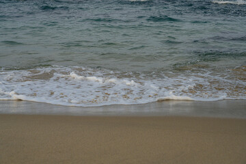 Peaceful Seaside Scene with Soft Waves and Golden Sand