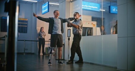 Security Checkpoint in Airport Terminal: African American Security Officer Inspecting Young Man...