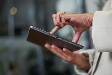 Close-Up of a Hand Operating a Digital Tablet in a Professional Setting
