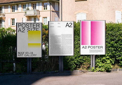 Mockup Of Three Vertical A2 Customizable Posters Outdoors
