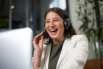 Smiling Businesswoman Working Online with Headset in Office Environment
