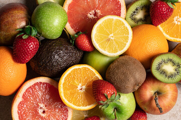 Set of fruits and berries close up view. Orange, grapefruit, avocado, lemon, kiwi, apple, pear and ripe strawberry