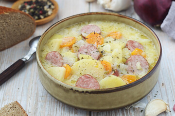 A bowl with traditional German potato soup with sausages