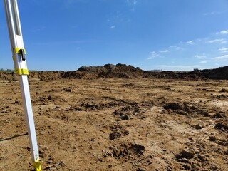 Survey equipment and construction site under clear blue sky