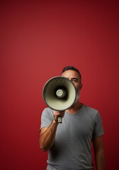 Man with megaphone against red background bold announcement. AI Generated