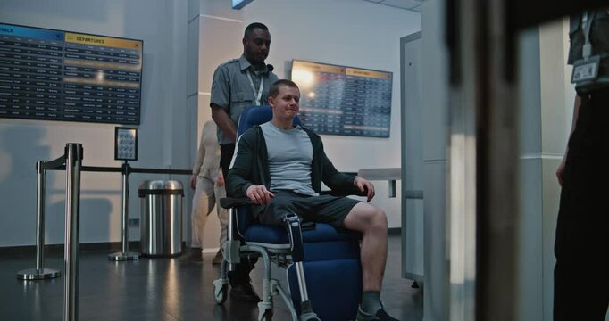 Security Checkpoint in Airport Terminal: Man with Prosthetic Leg Getting Up from Wheelchair, Passing X-ray Metal Detector Scanner, Security Staff Helping Man. Passengers During Screening Procedures.