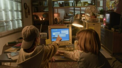 Wide angle back view of two boys using retro computer in warm toned 90s room setting - Powered by Adobe