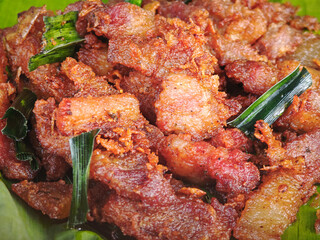 fried pork on banana leaves