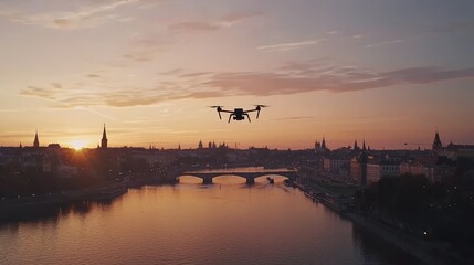 Naklejka premium Capturing an aerial view of the city bathed in the fiery glow of the setting sun is achieved by a sleek drone with glowing lights navigating the urban landscape