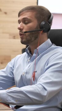 Engaging telemarketer communicating with customers over the phone. Vertical footage