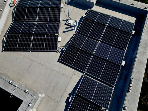 extensive roof of industrial and logistic hall are gradually being filled with solar panels. covering roofs helps industrial developer increase energy efficiency and sustainability site, building 