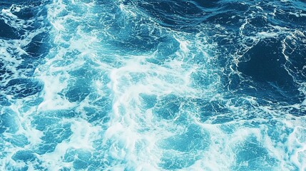 Pure blue turquoise water texture of the ocean sea with foam from and waves

