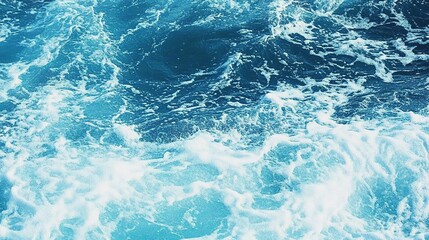 Pure blue turquoise water texture of the ocean sea with foam from and waves
