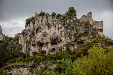An antique book displayed against a neutral background, showcasing its rich wear and tear. The book's aged pages and cover highlight its historical significance and charm.