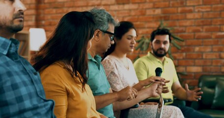 Indian Asian young business professionals or startup team attending a corporate training session, engaging in an interactive leadership lecture, asking questions, sharing insights in conference room
