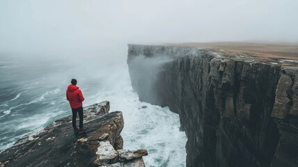 Obraz premium Man on Cliffside, Contemplating the Vast Ocean