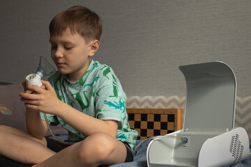 Child using inhaler nebulizer at home. Asthma attack concept