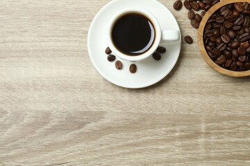 Cuo of coffee with coffee beans on wooden background