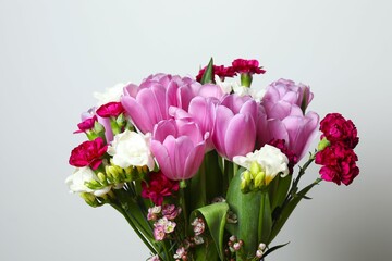 Beautiful bouquet of fresh flowers on a gray background